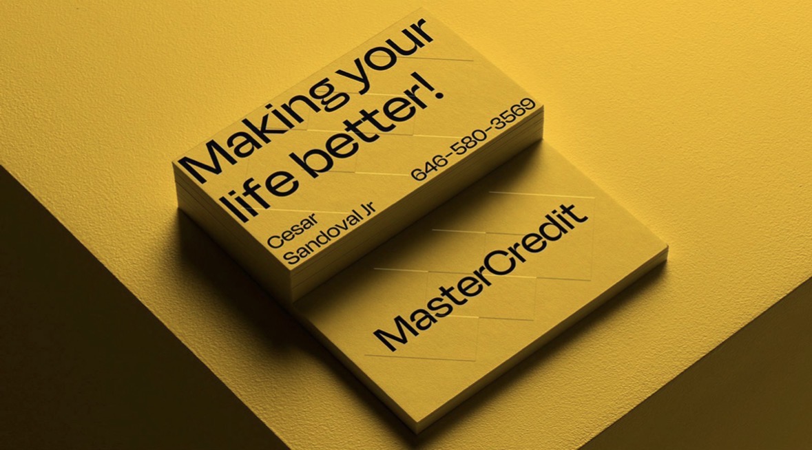 Stack of yellow MasterCredit business cards with black typography